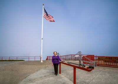 Eve Meyer, the former executive director of San Francisco Suicide Prevention (SFSP), poses next to a model of the Golden Gate Bridge.