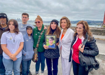 Former U.S. Speaker of the House and California Senator Nancy Pelosi stands 2nd from the right with attendees at the Golden Gate Bridge Suicide Deterrent Commemoration Ceremony.